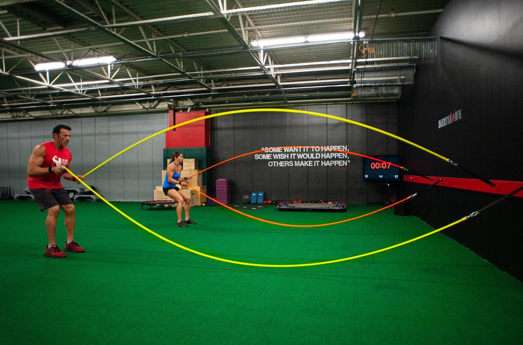 Man and Woman Working Out With Inertia Wave Pros