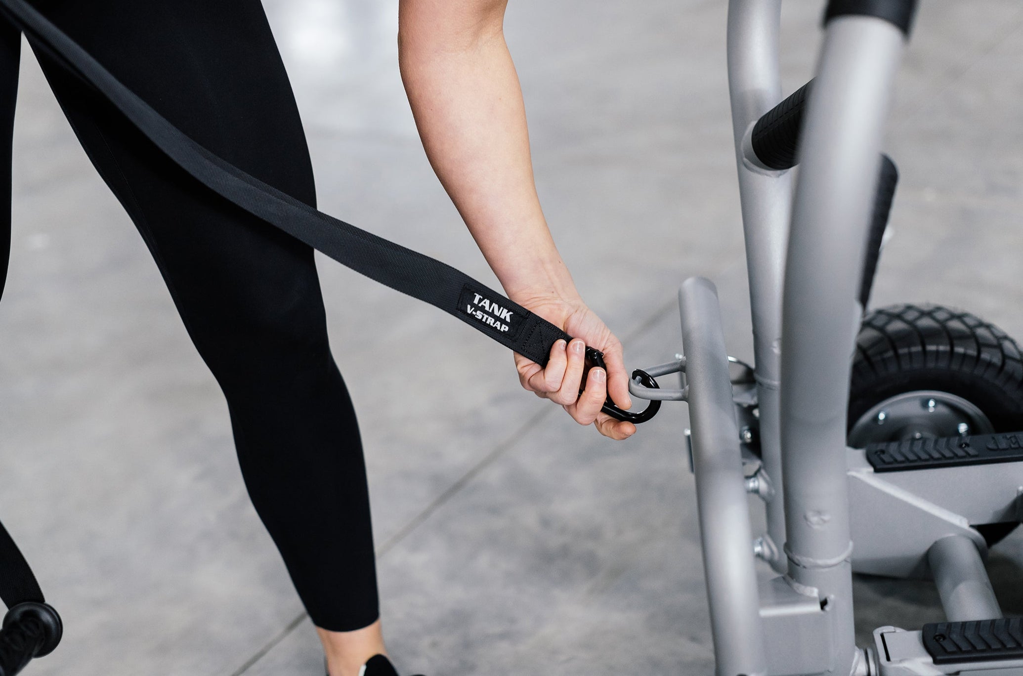 Woman Clipping TANK V-Strap Onto TANK MX